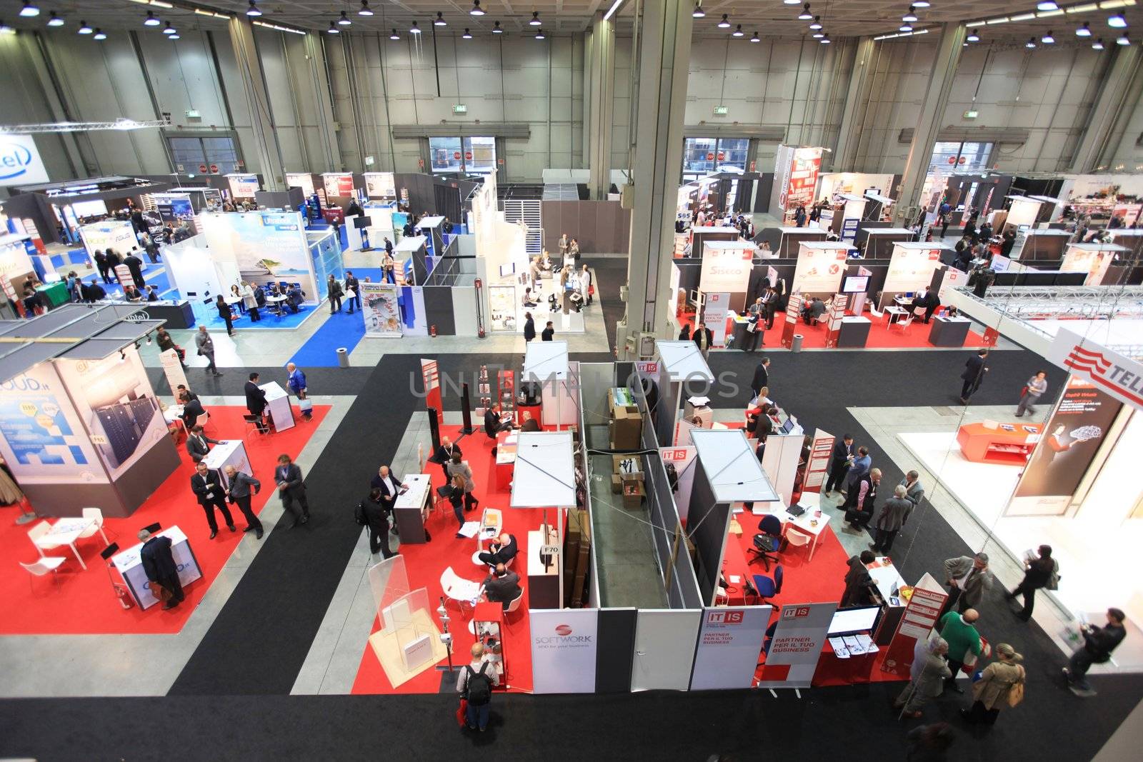 MILAN, ITALY - OCTOBER 17: People visit technologies products exhibition area at SMAU, international fair of business intelligence and information technology October 17, 2012 in Milan, Italy.