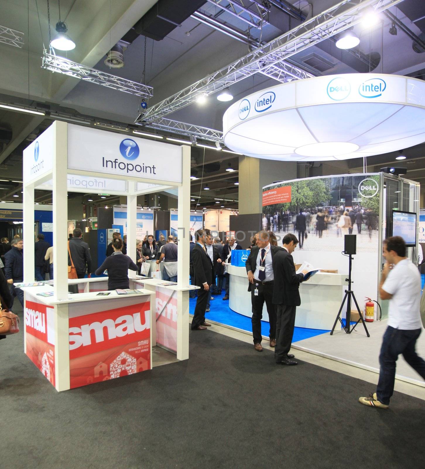 MILAN, ITALY - OCTOBER 17: People visit technologies products exhibition area at SMAU, international fair of business intelligence and information technology October 17, 2012 in Milan, Italy.