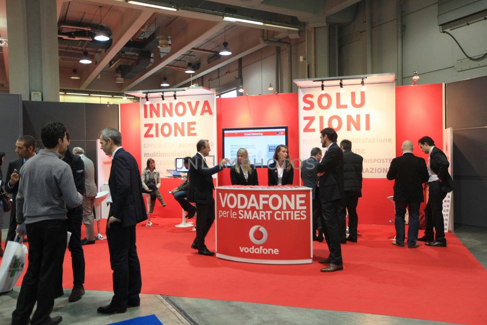 MILAN, ITALY - OCTOBER 17: People visit Vodafone technologies products exhibition area at SMAU, international fair of business intelligence and information technology October 17, 2012 in Milan, Italy.