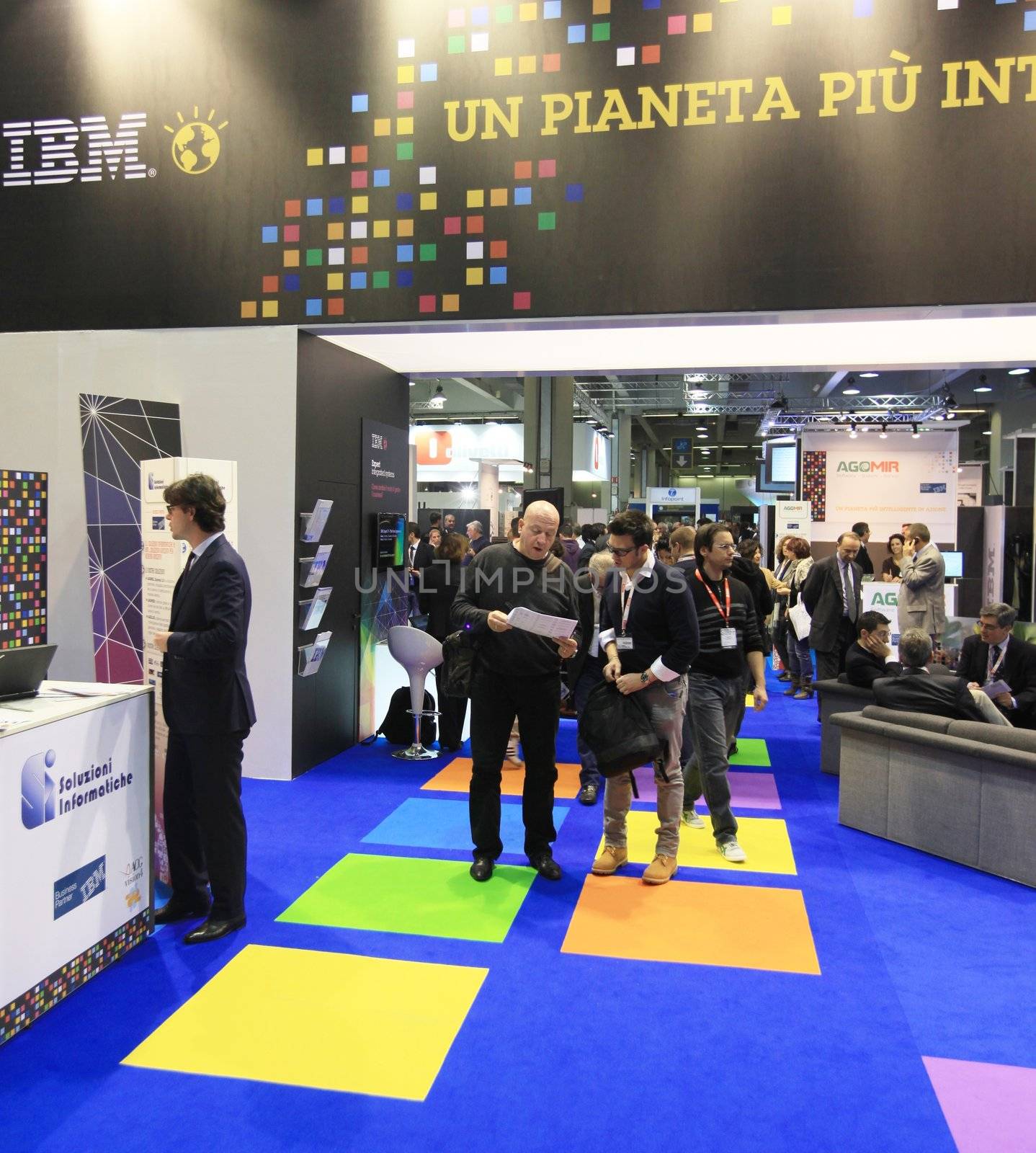 MILAN, ITALY - OCTOBER 17: People visit IBM technologies products exhibition area at SMAU, international fair of business intelligence and information technology October 17, 2012 in Milan, Italy.