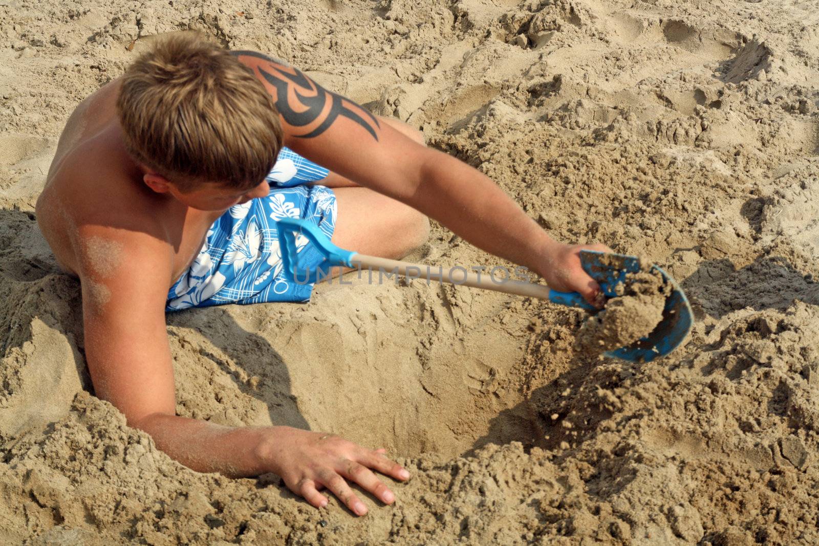 teenage boys playing in the sand by lizapixels