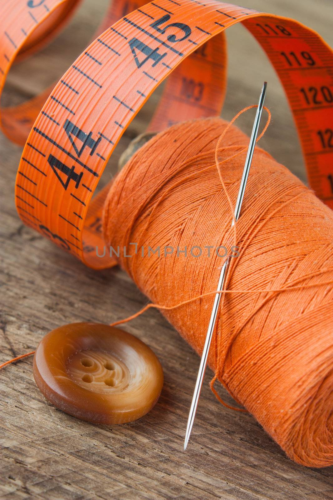 Sewing on the background of the old wooden walls