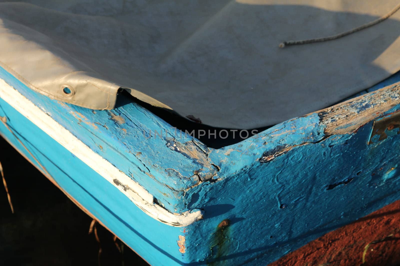 Detail of the bow of a blue fishing boat
