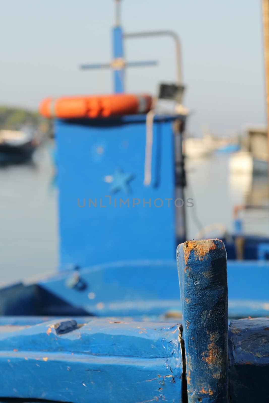 Close up of a docked blue fishing boat in a small village in the south of Italy
