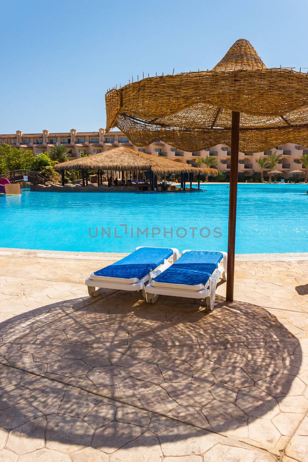  the pool, beach umbrellas and the Red Sea in Egypt  by oleg_zhukov