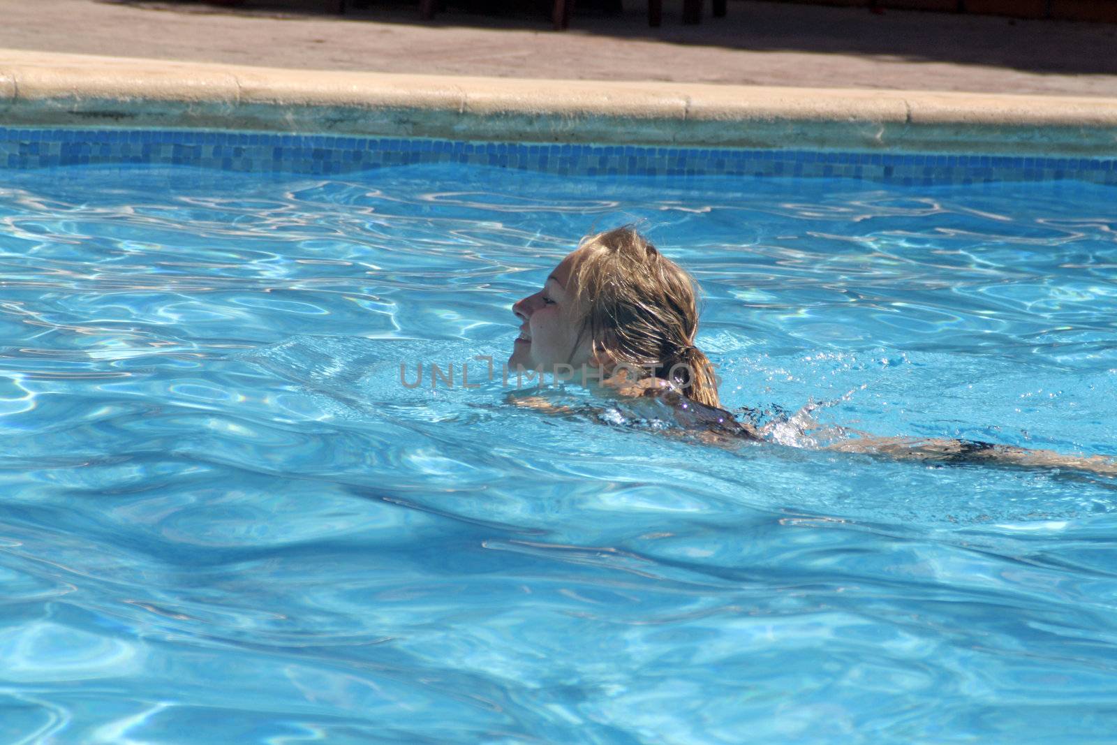 teenage girl in the swimming pool by lizapixels