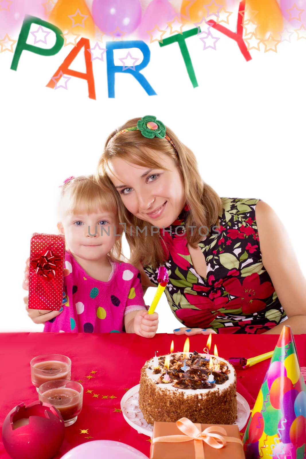Mother and little girl at party table with gifts and cake