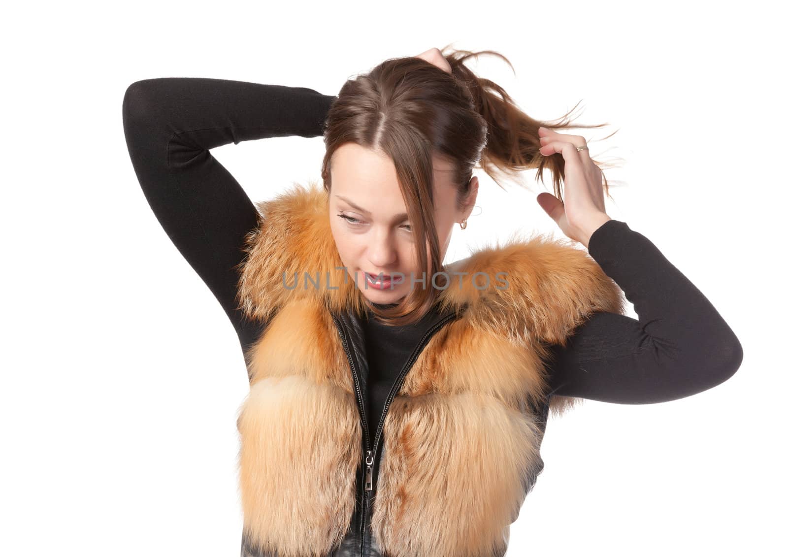 Stylish relaxed young woman in winter fur jacket isolated on white