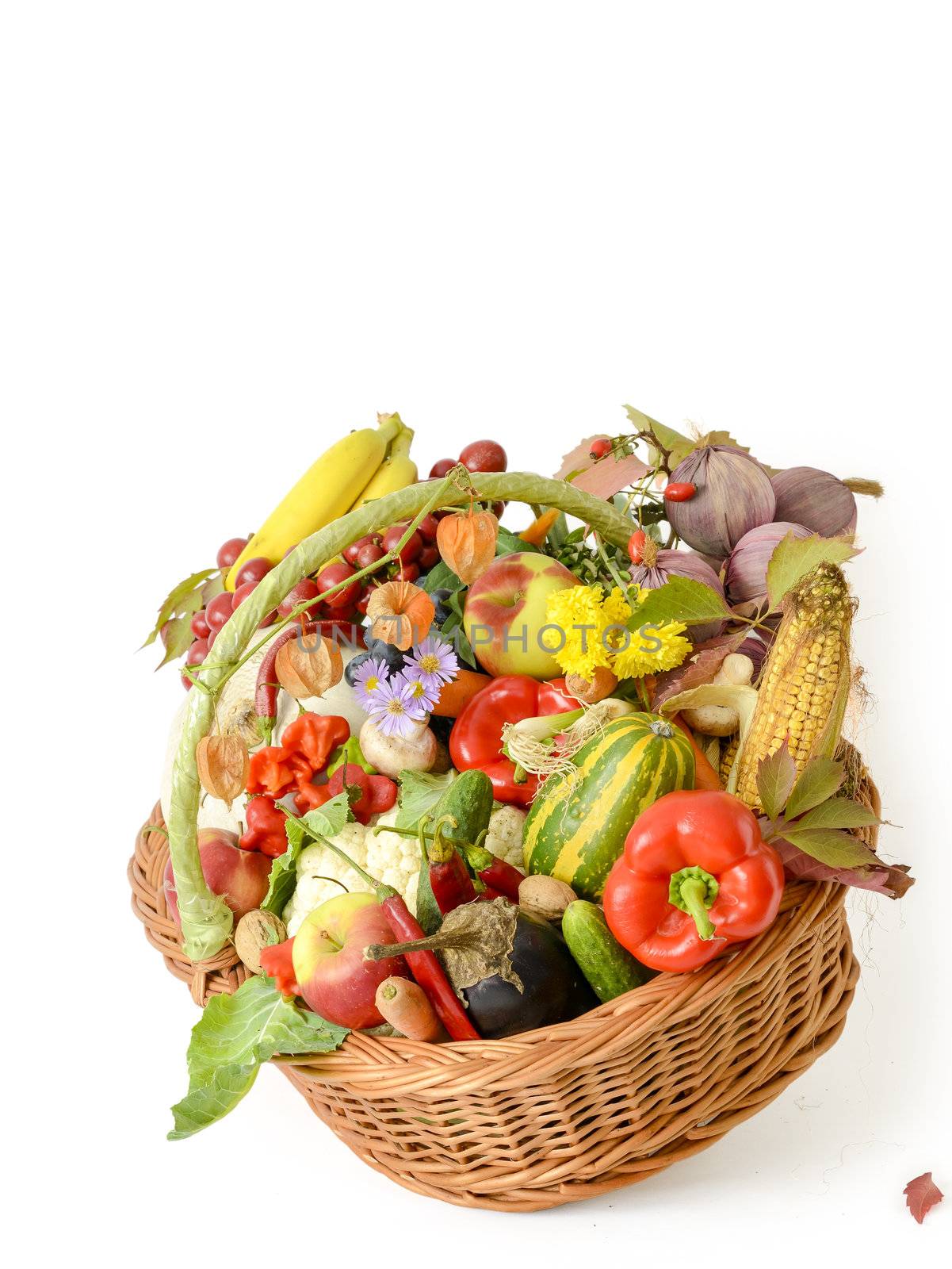 Variety of raw vegetables in wicker basket isolated on white background