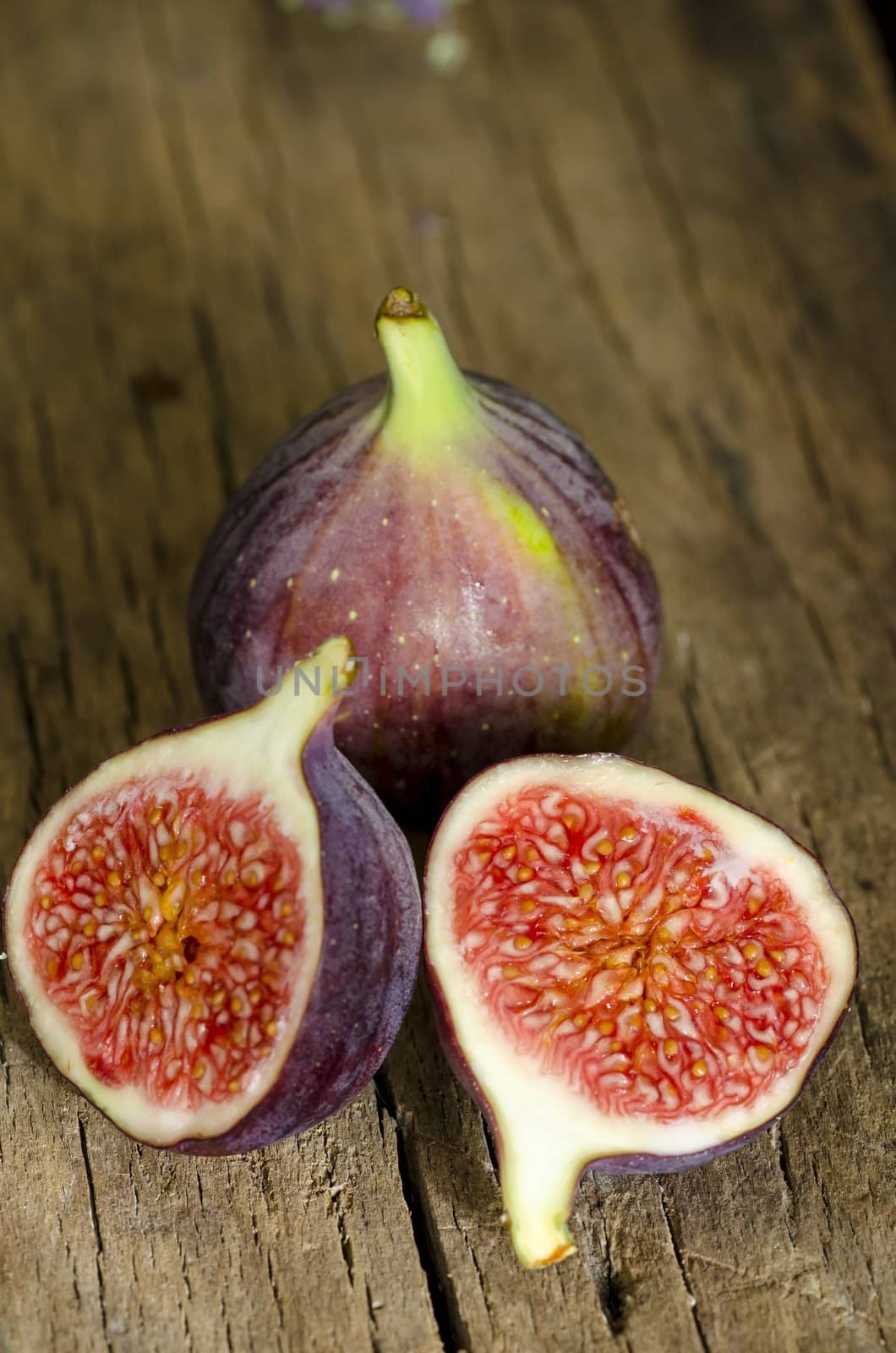 Ripe figs on wooden background