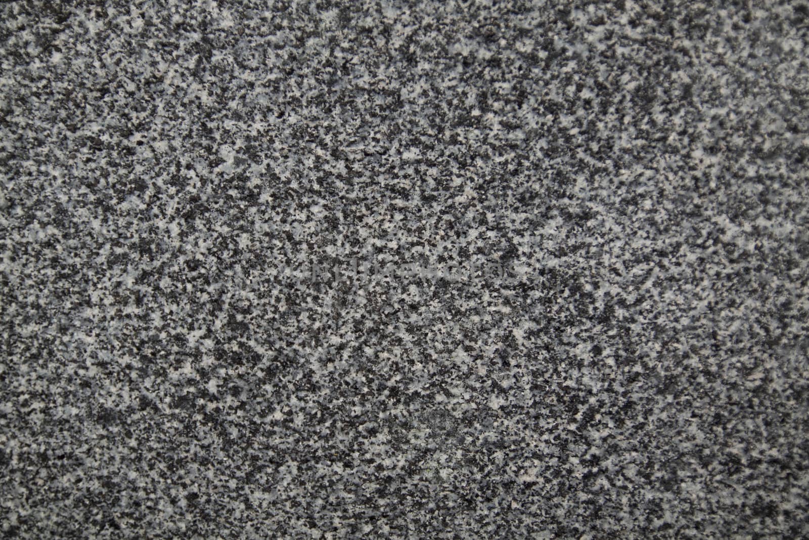 Closeup of dark grey granite texture by dannyus