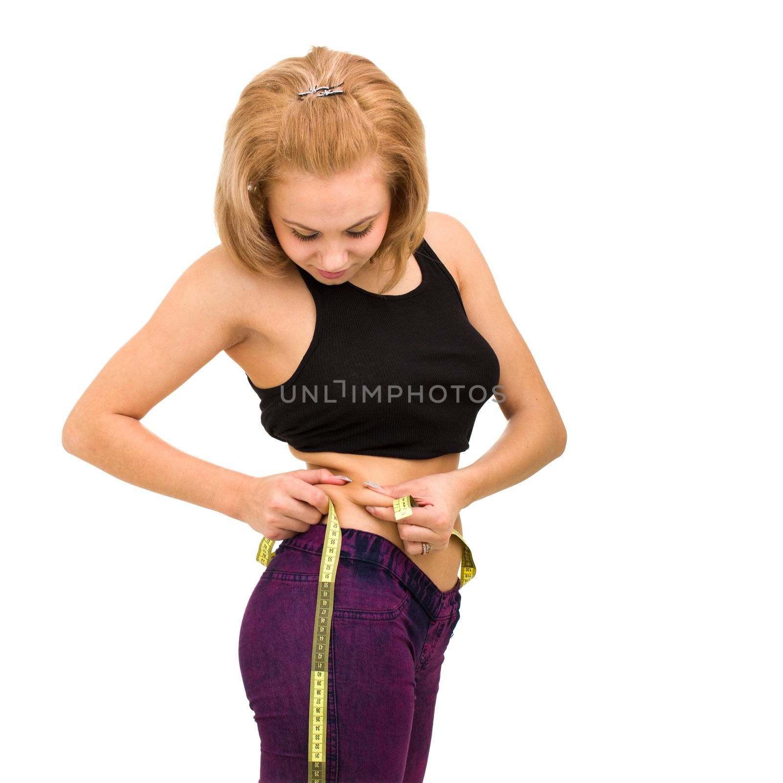 Time to lose weight! Beautiful young woman measuring her waist, isolated on white background
