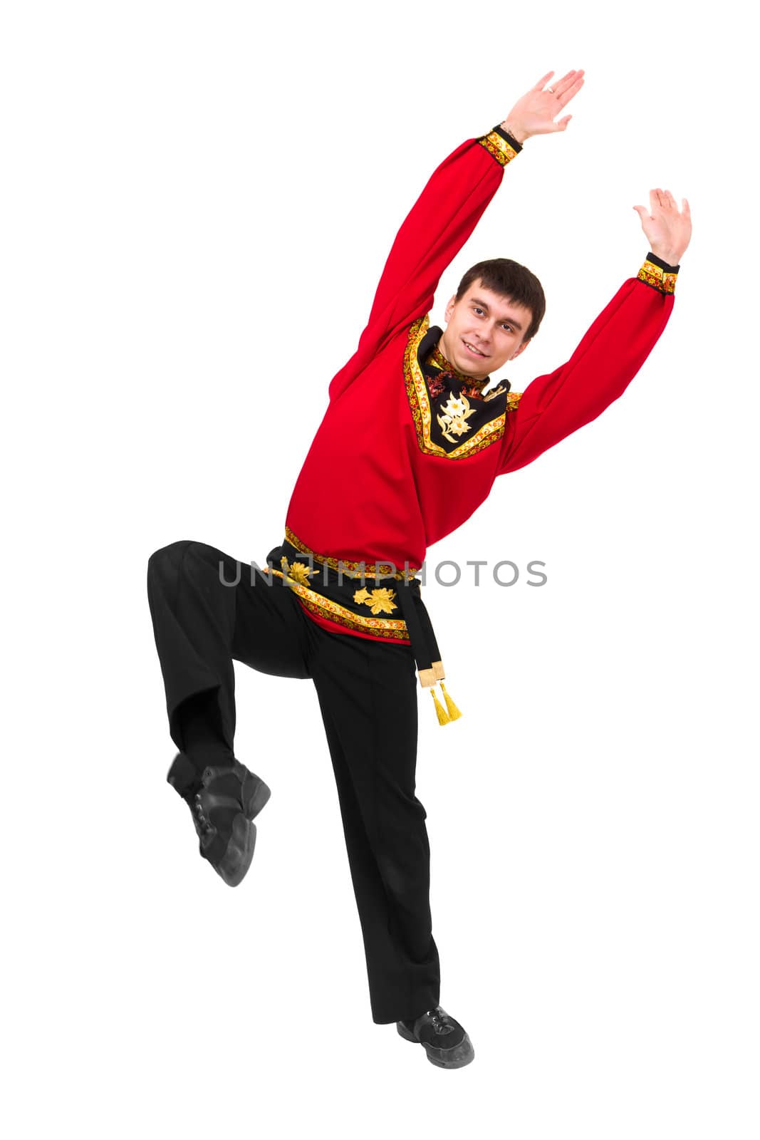 young man wearing a folk russian costume dancing by stepanov