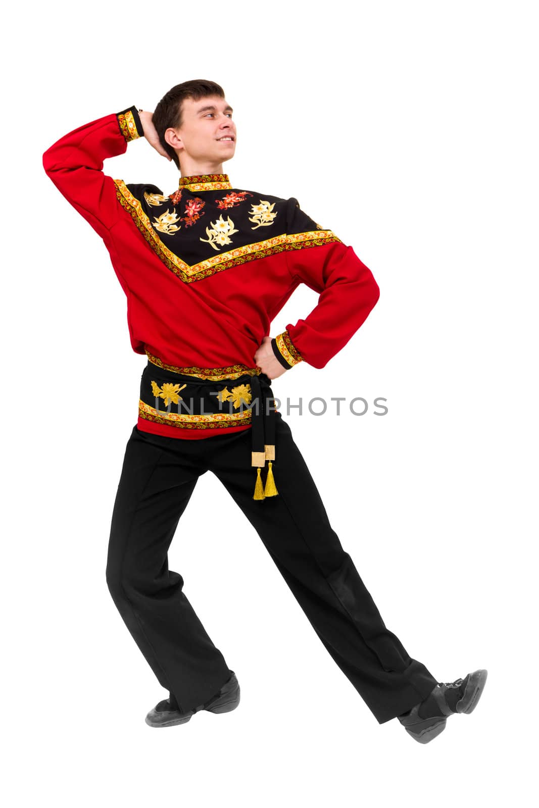 young dancer wearing a folk russian costume dancing against isolated white background