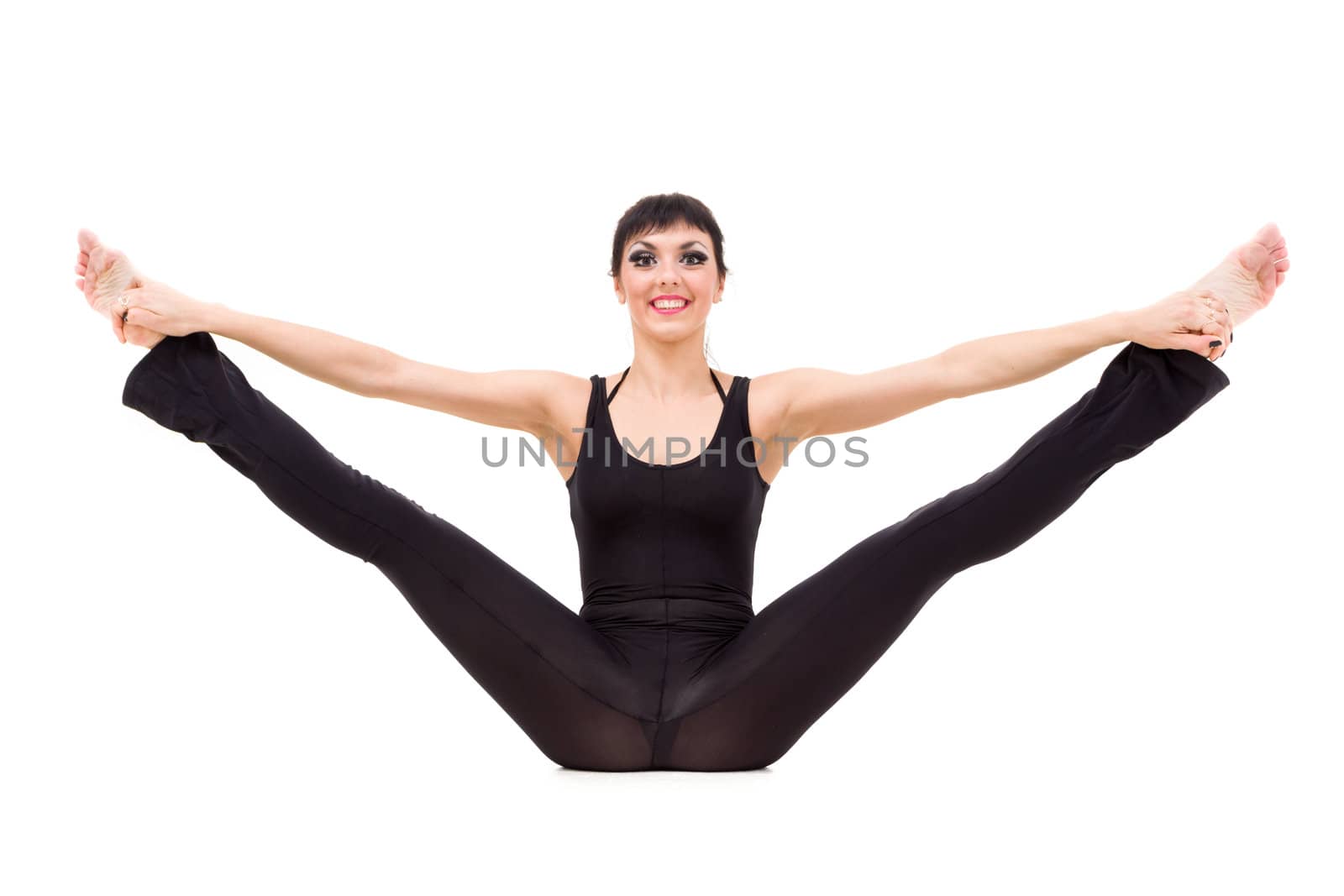 Young smiling woman makes splits against isolated white background