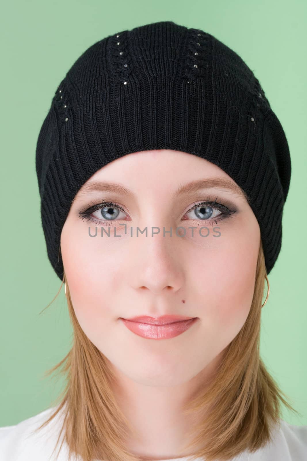 young woman wearing a winter cap by stepanov