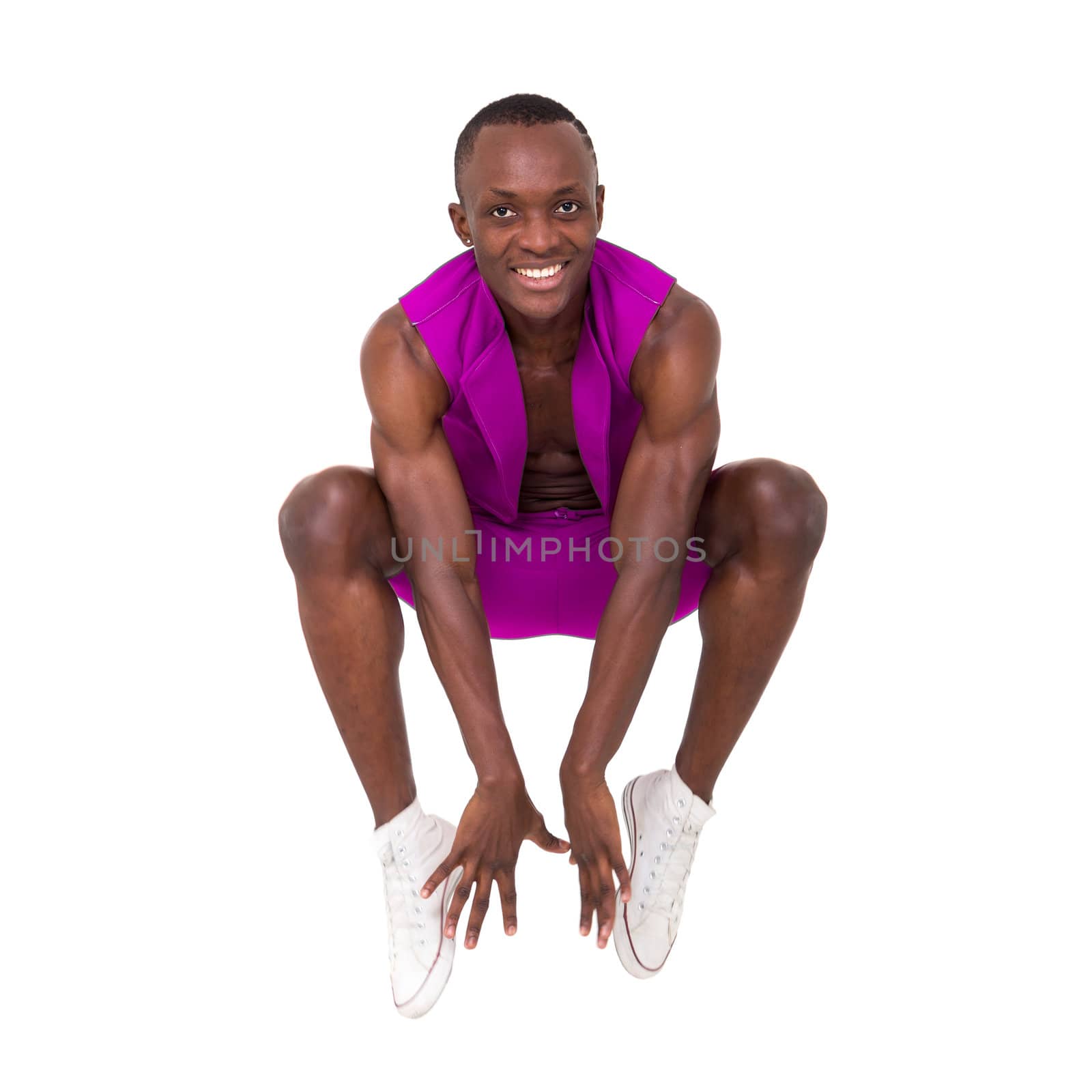 Happy young man jumping against isolated white background