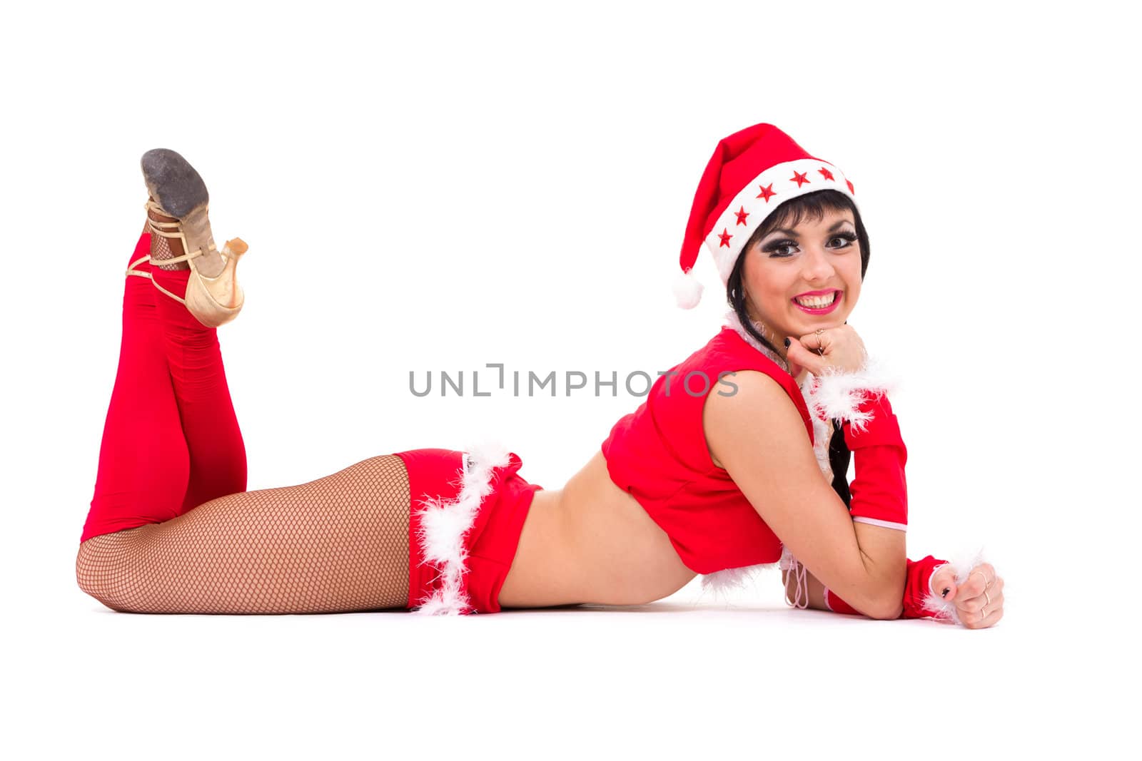 beautiful girl wearing santa claus clothes lies on a white background