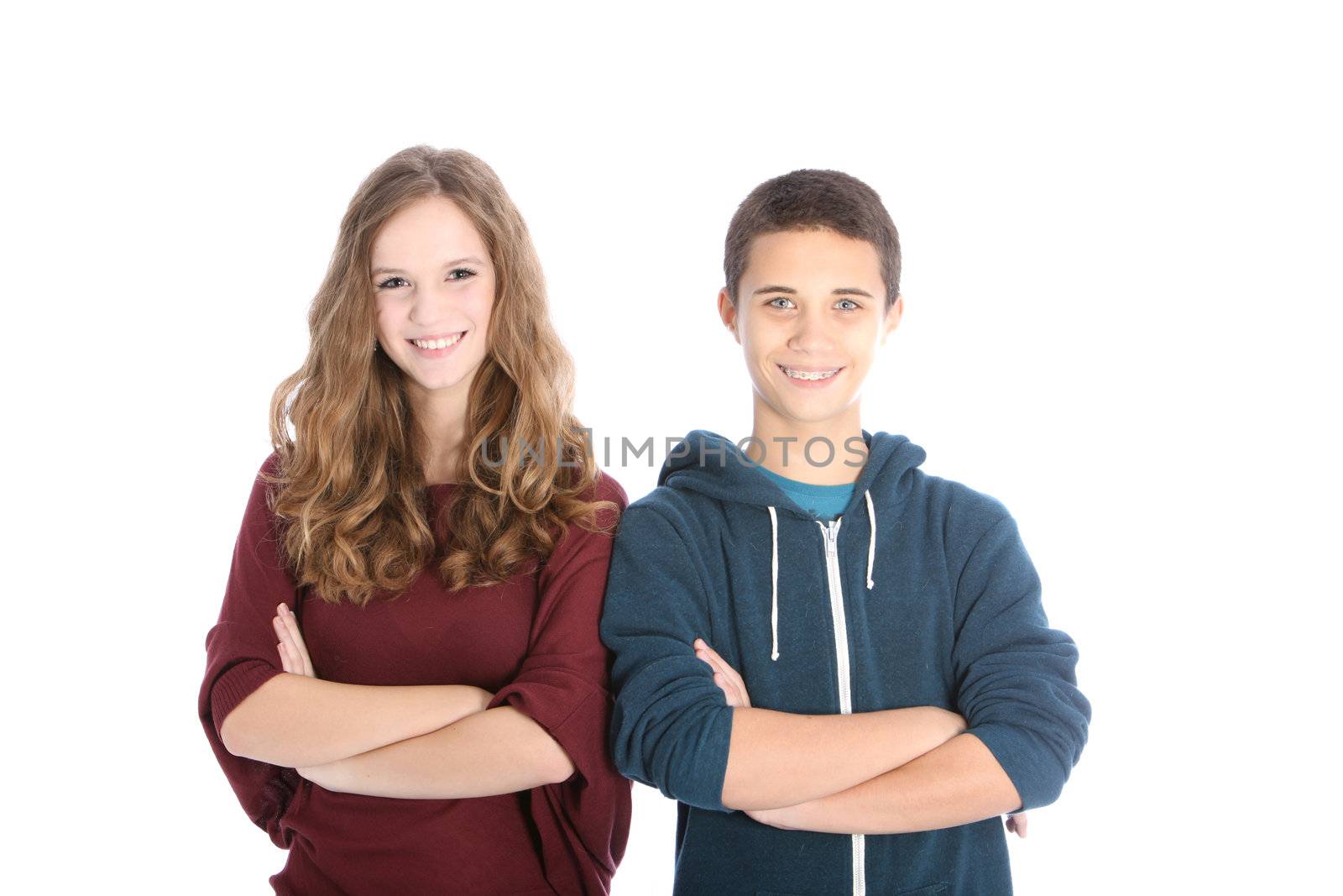 Young attractive dating teenagers or siblings standing side by side with lovely broad beaming smiles isolated on white