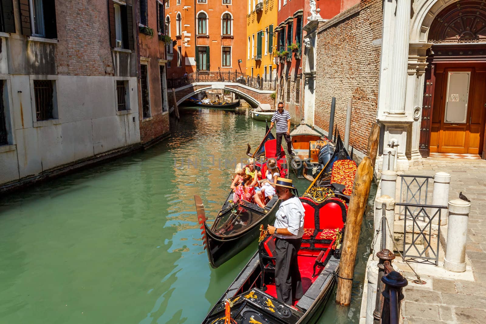 16. Jul 2012 - Tourists on gondolas at canal in Venice, Italy 