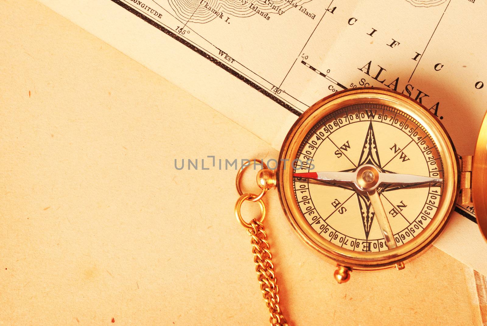 Antique brass compass over old map by haveseen