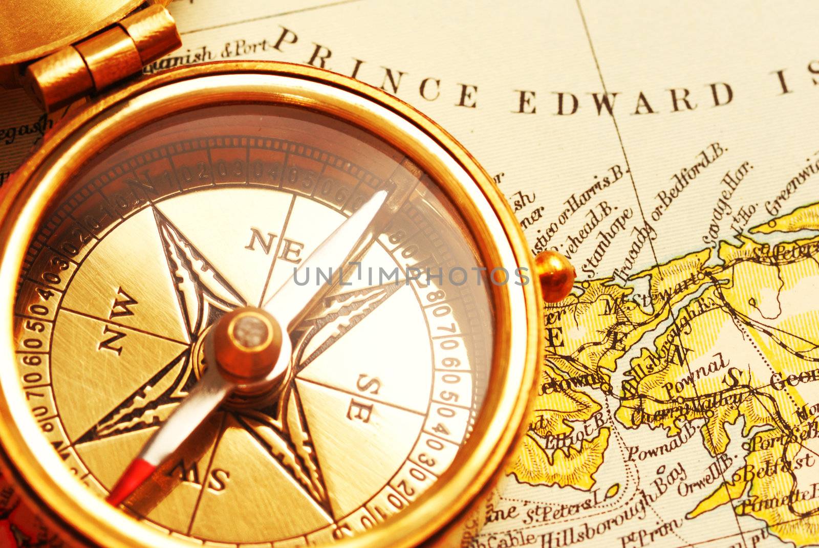 Antique brass compass over old Canadian map background                                    