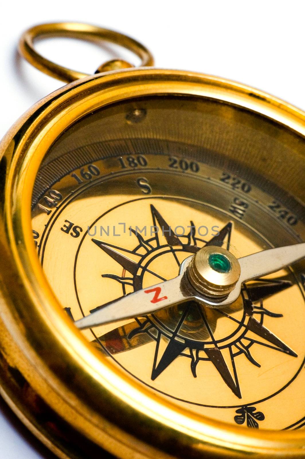 Old style brass compass on white background