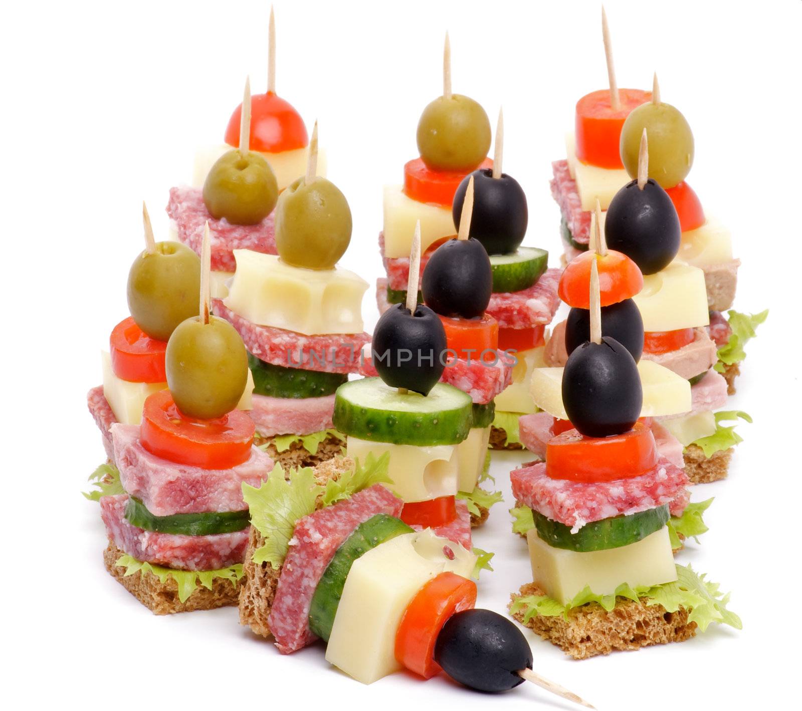 Arrangement of Canape with Bacon, Salami, Tomatoes, Cheese, Cucumber, Green Olive, Black Olive, Lettuce and Whole Grain Bread isolated on white background