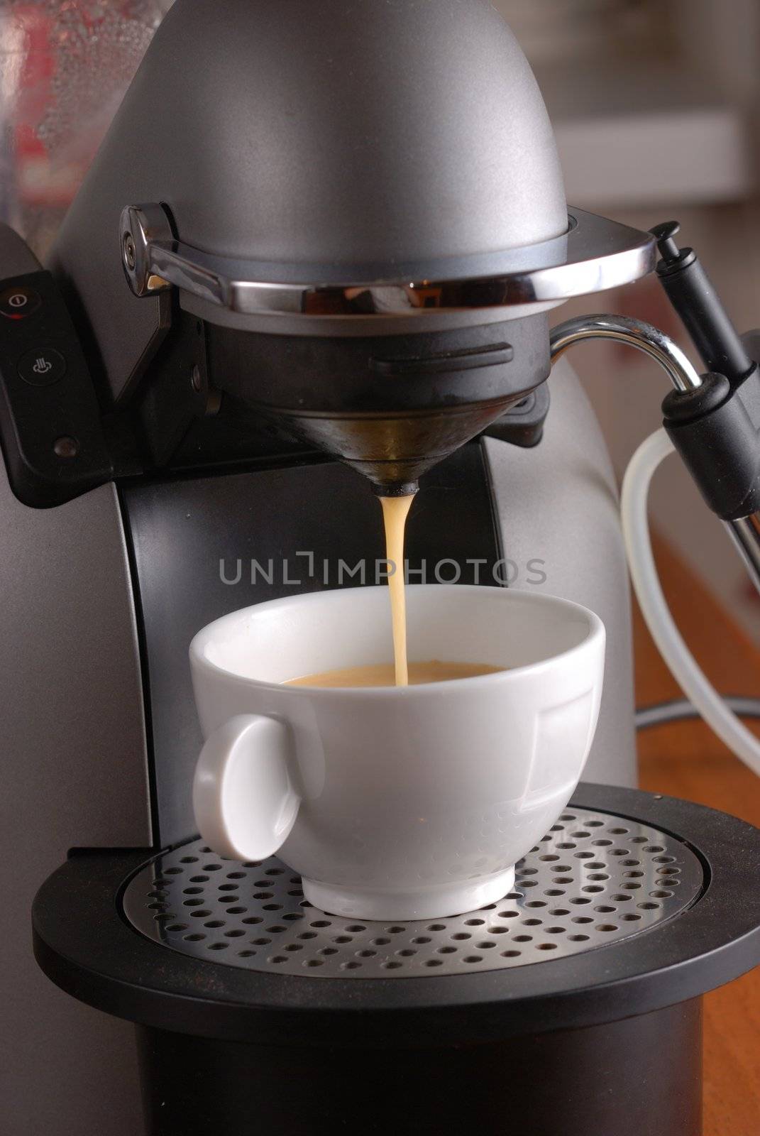 Coffee machine pouring espresso in cup