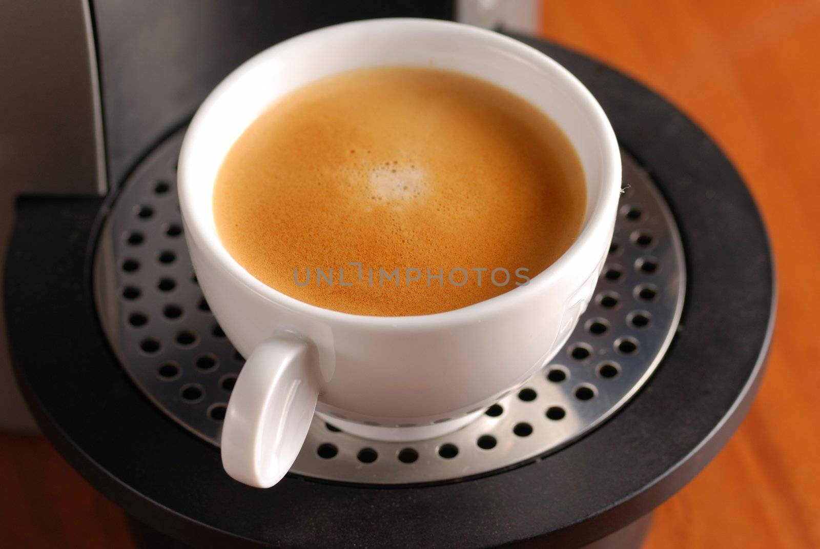 Coffee machine and cup of espresso 