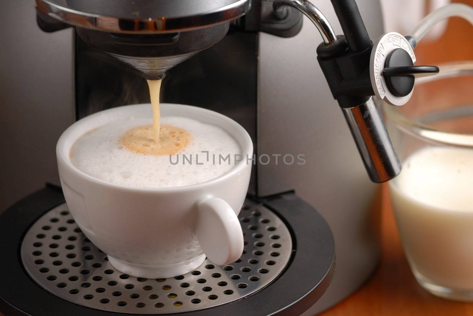 Making cappuccino with coffee machine