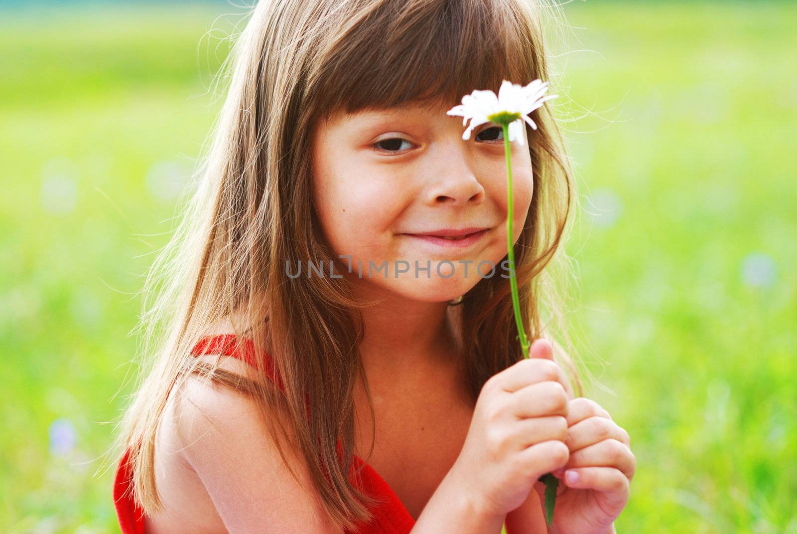 Little cute girl with flower outdoors