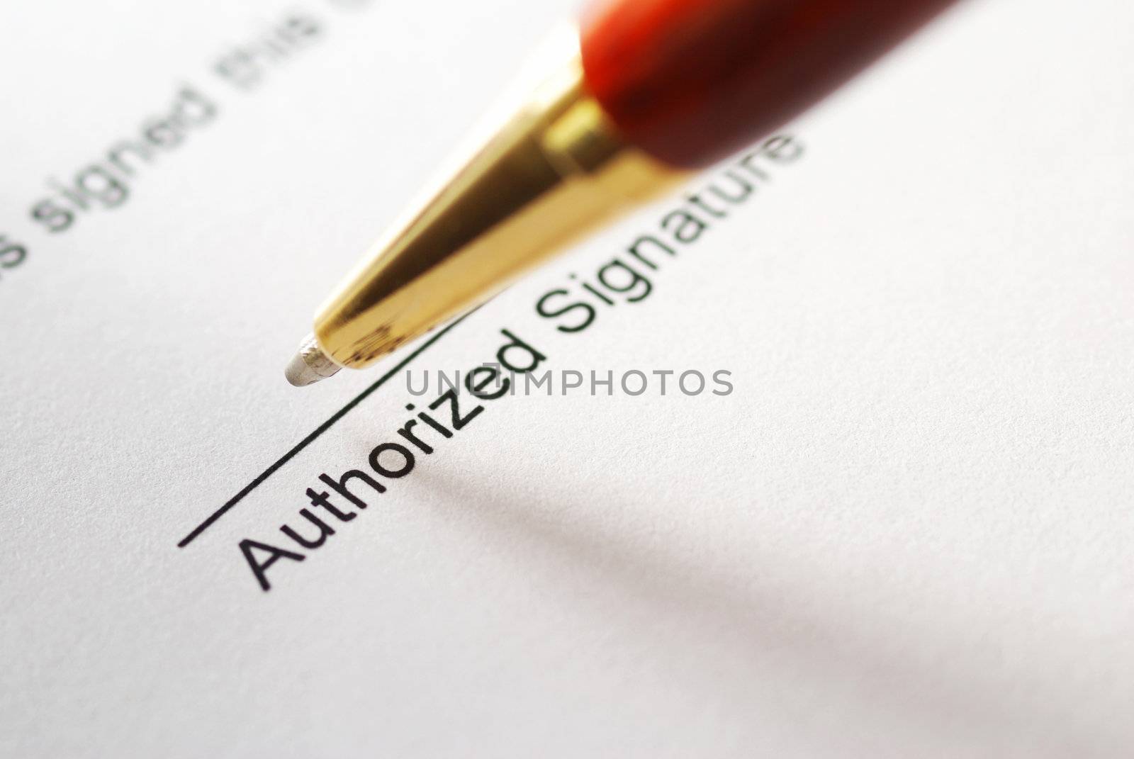 Signing a contract. Shallow depth of field.