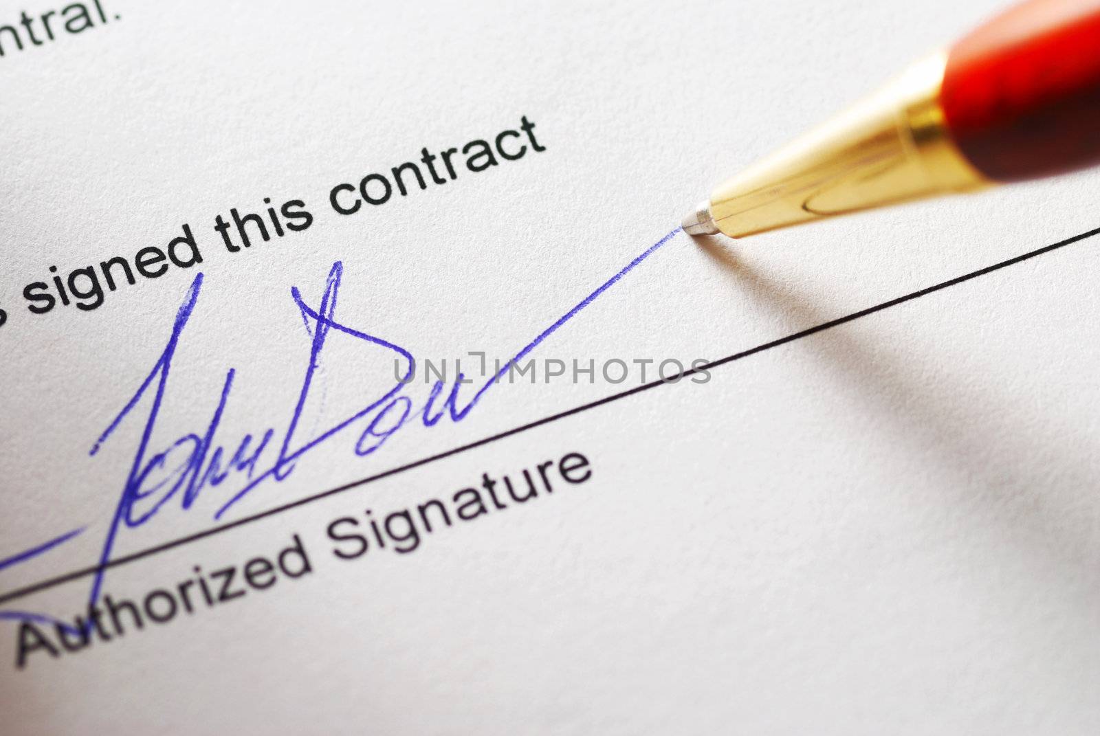 Signing a contract. Shallow depth of field.
