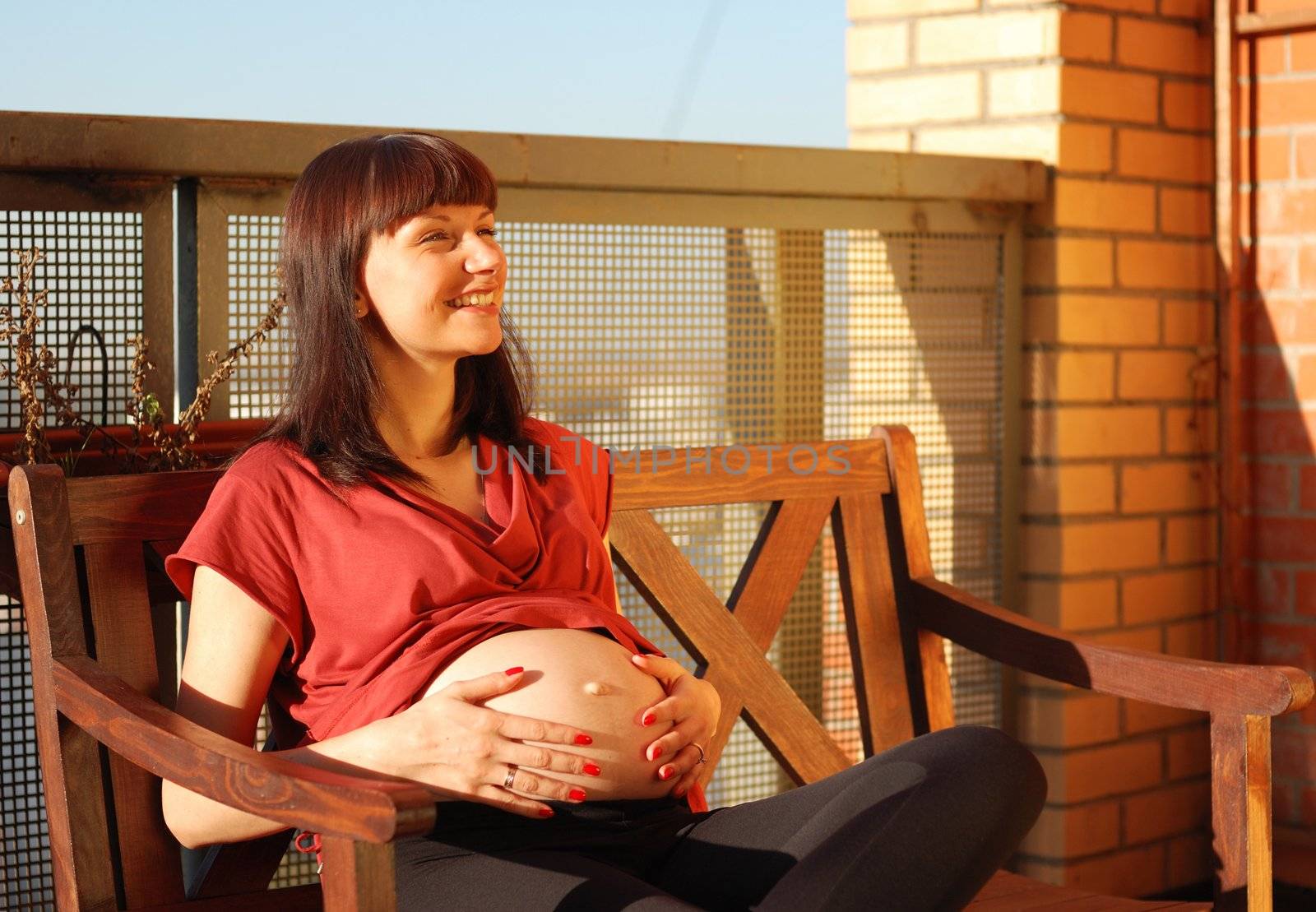 Pregnant woman waiting for a first child. Sunlight.