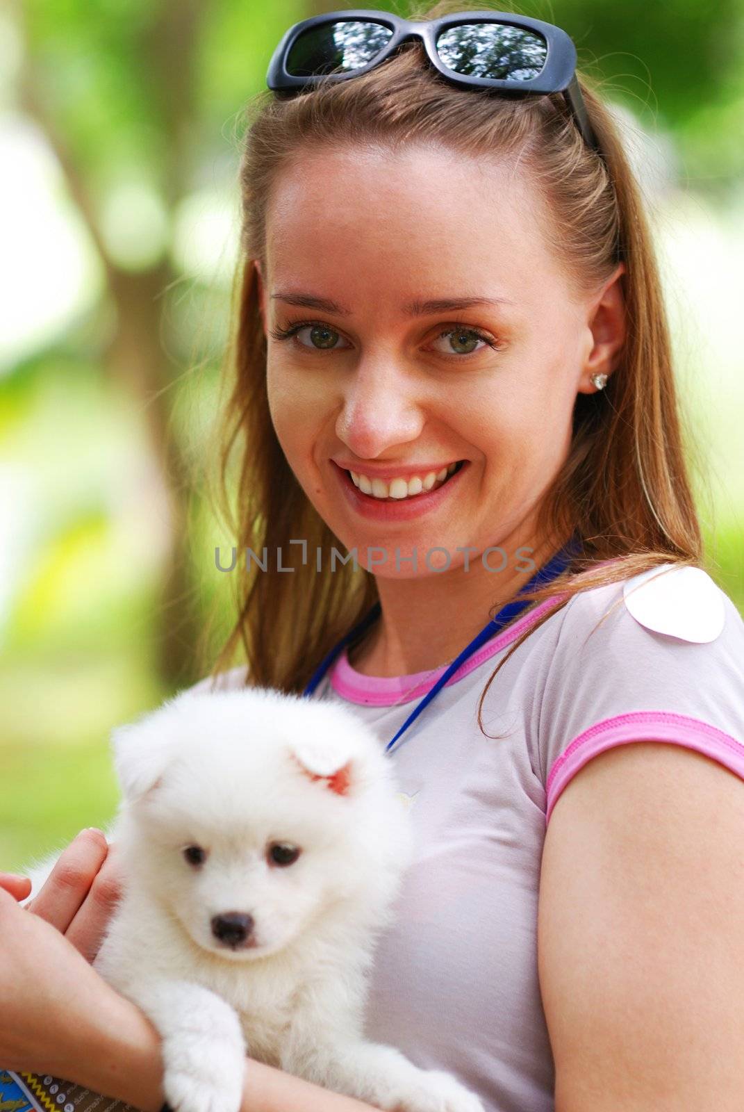 Girl with cute white puppy