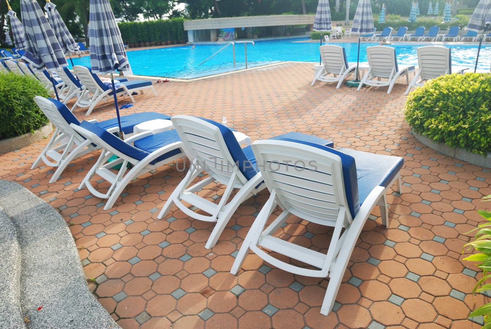 Patio with chaise lounges near luxury hotel