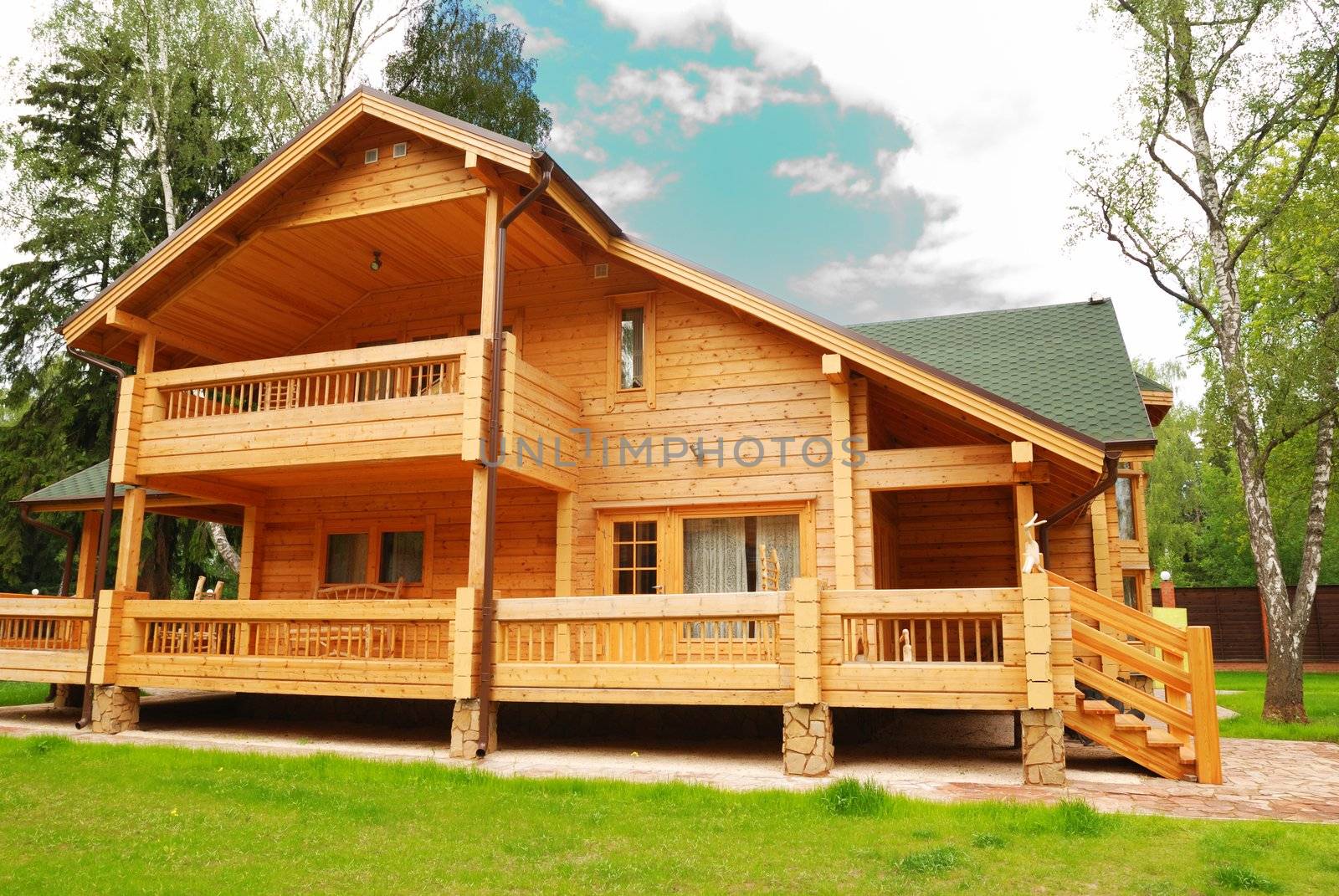 Wooden house with meadow in front of it