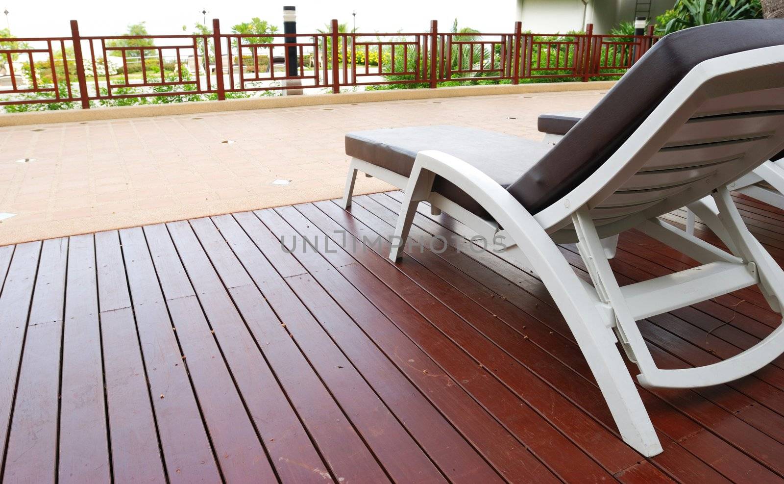 Patio with chaise lounges near luxury hotel