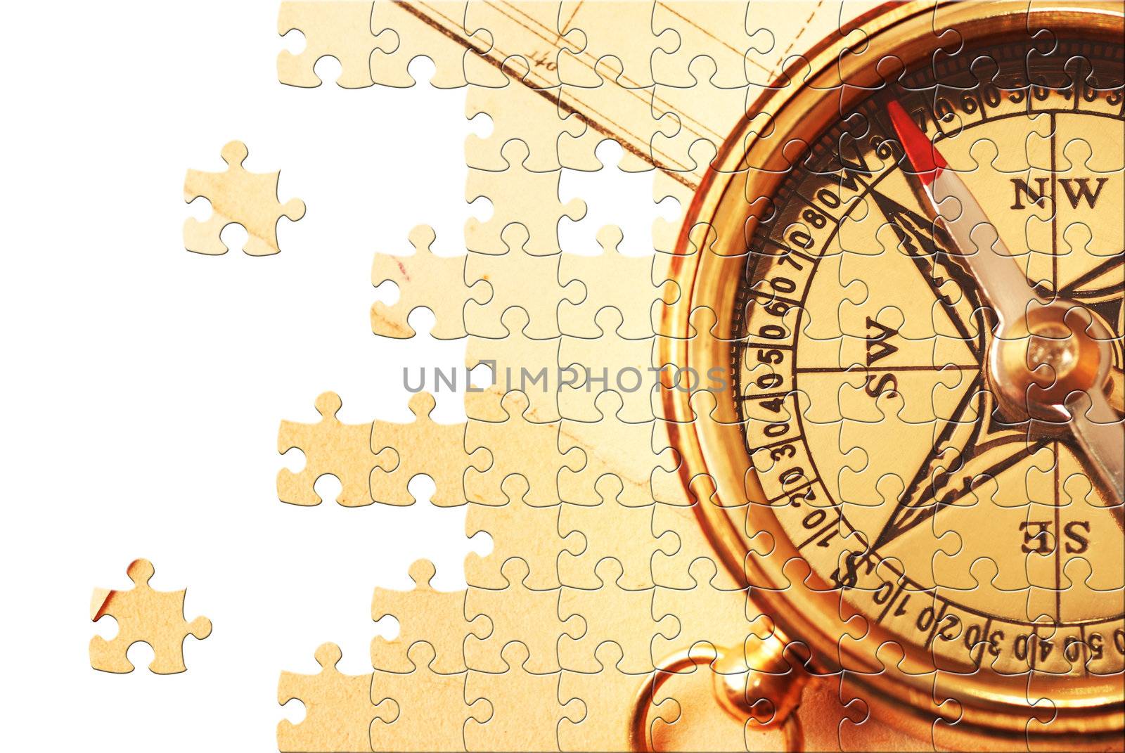 Puzzle Antique brass compass over old map background