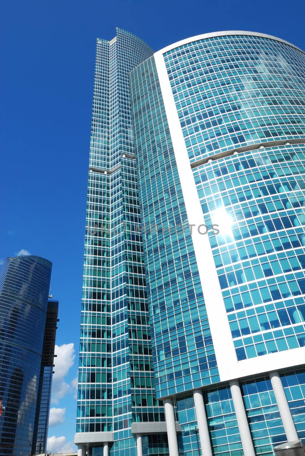 Modern office building with sky reflection in windows