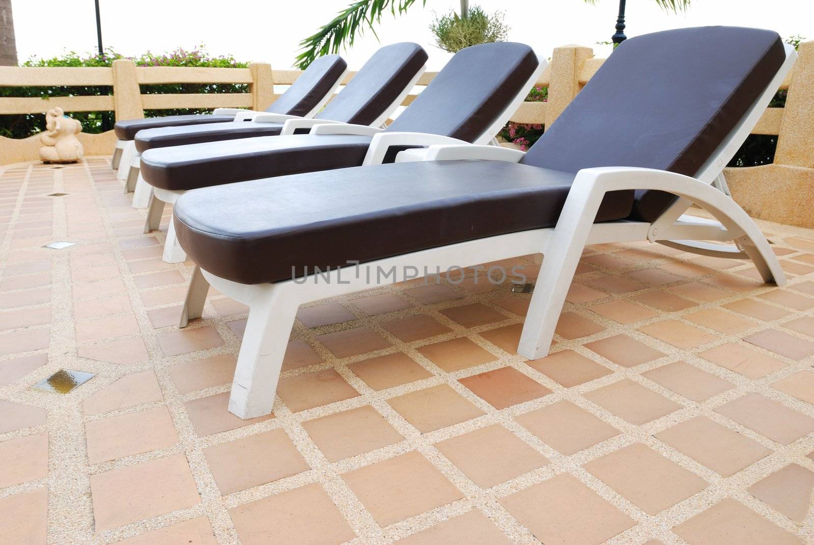 Patio with chaise lounges near luxury hotel