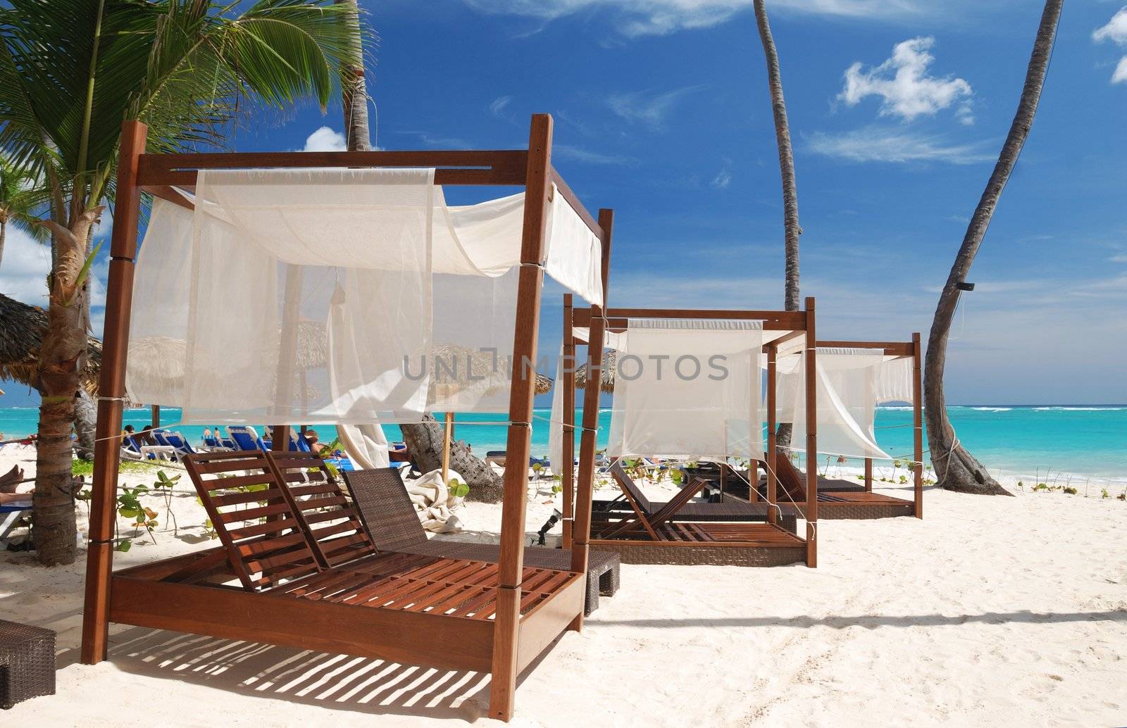 Luxury wooden chaise lounge on beautiful caribbean beach in Dominican Republic