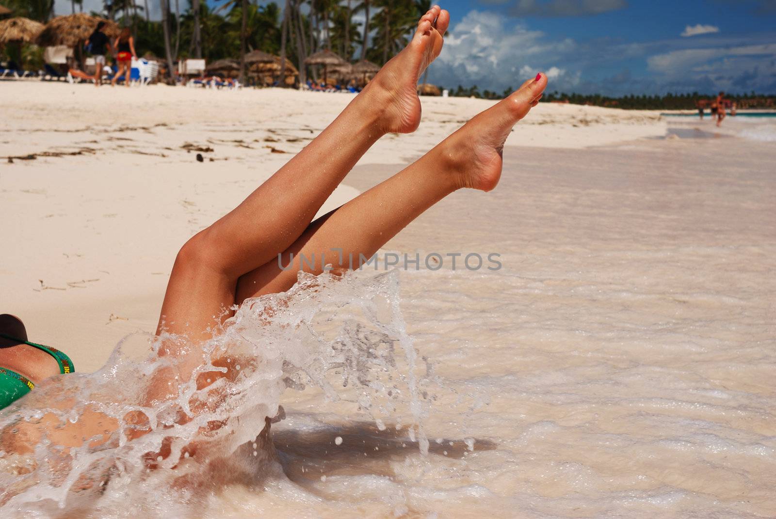 Women's sexy legs on the beach