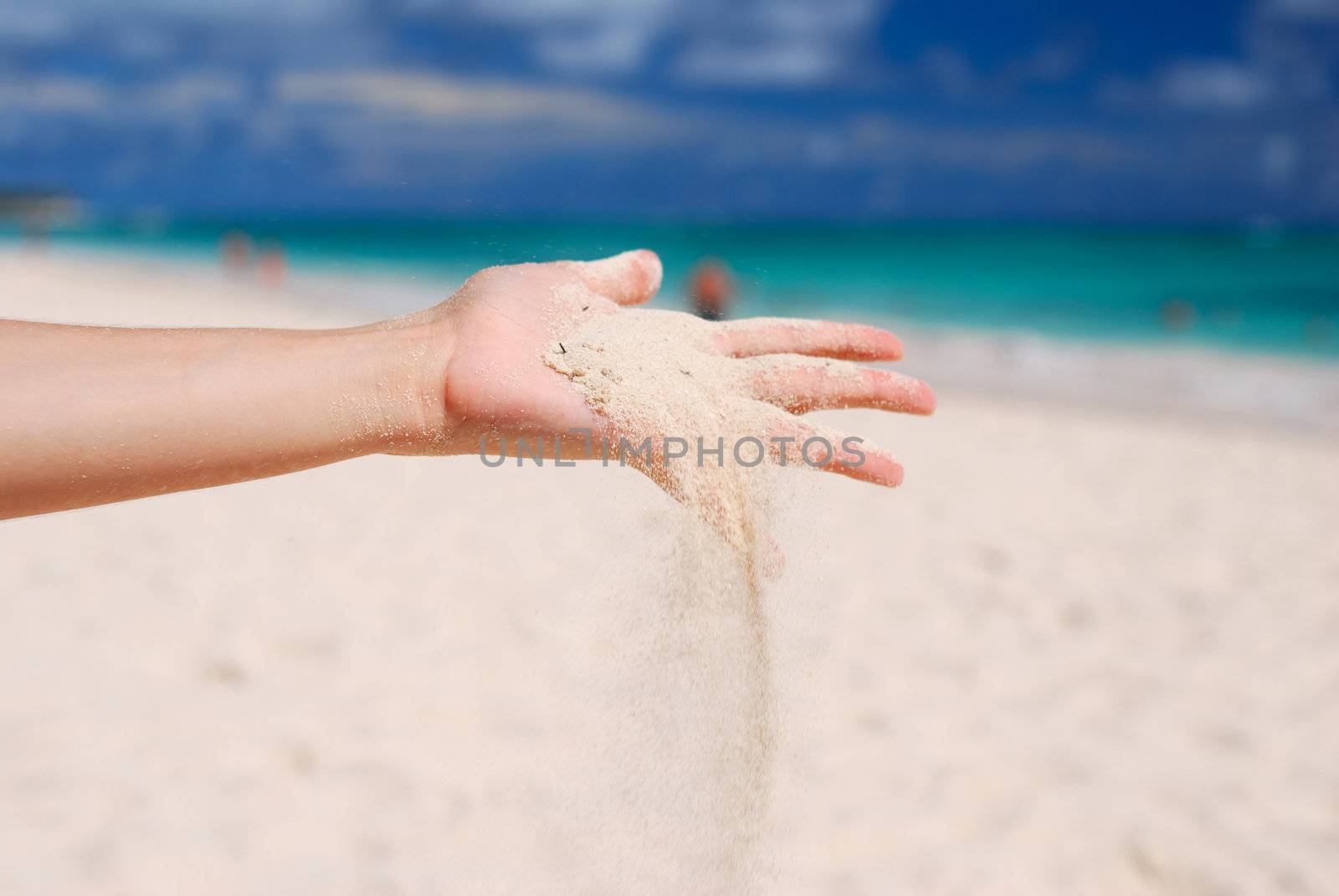 Coral white sand strewing from hand