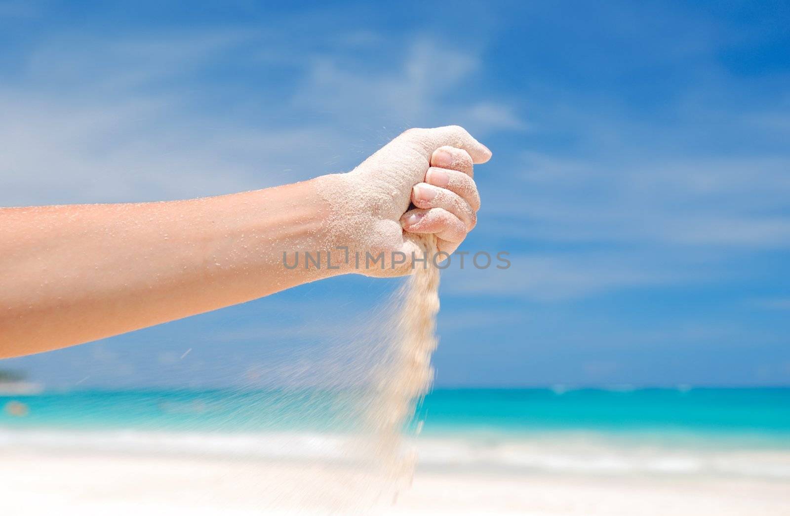 Coral white sand strewing from hand
