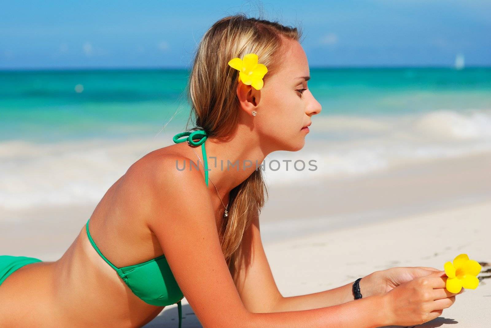 Girl with flower on caribbean beach