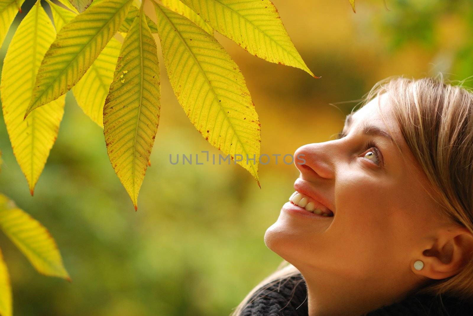 Girl with yellow autumn leaves