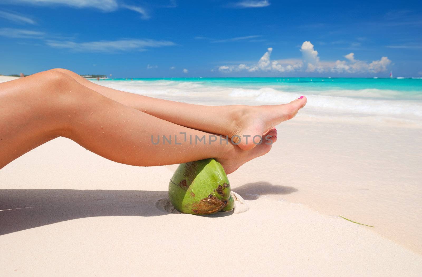 Women's sexy legs on the beach