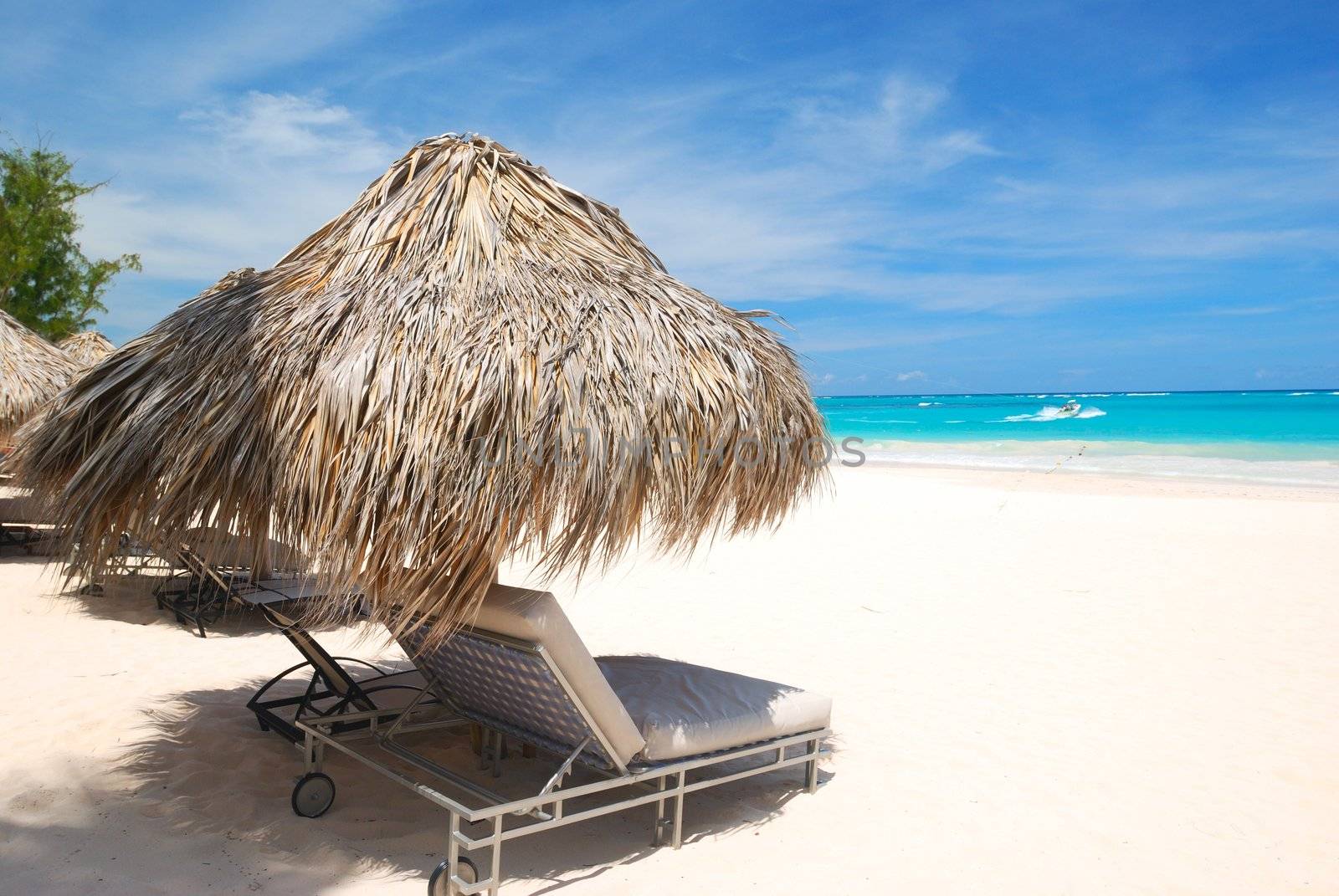 Beautiful caribbean beach with chaise lounge in Dominican Republic